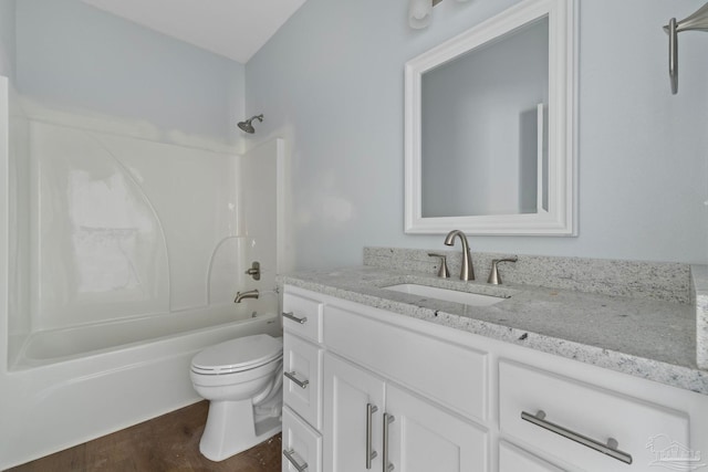 full bathroom with toilet, vanity, wood-type flooring, and washtub / shower combination