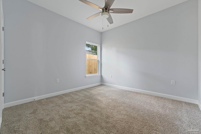 carpeted empty room featuring ceiling fan