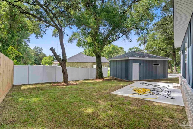 view of yard featuring an outdoor structure and a patio