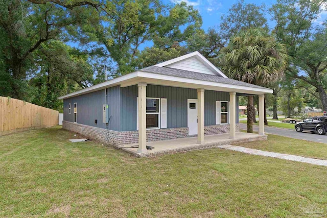 view of front of home with a porch and a front lawn