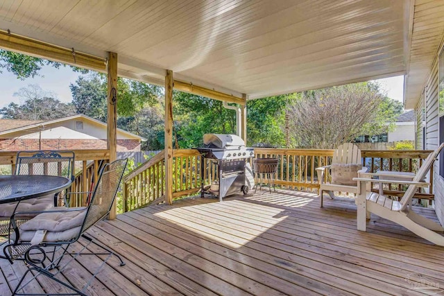 wooden terrace featuring a grill