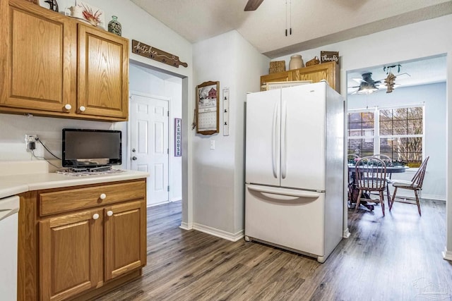 kitchen with lofted ceiling, dark wood-type flooring, and white appliances