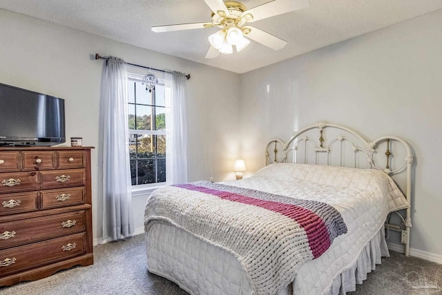 bedroom with carpet flooring, a textured ceiling, and ceiling fan