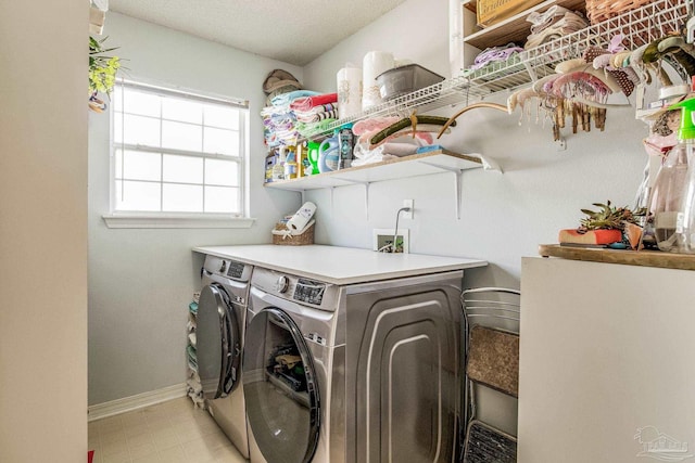 laundry room with independent washer and dryer and a textured ceiling