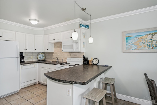 kitchen featuring decorative light fixtures, white cabinets, a kitchen breakfast bar, kitchen peninsula, and white appliances