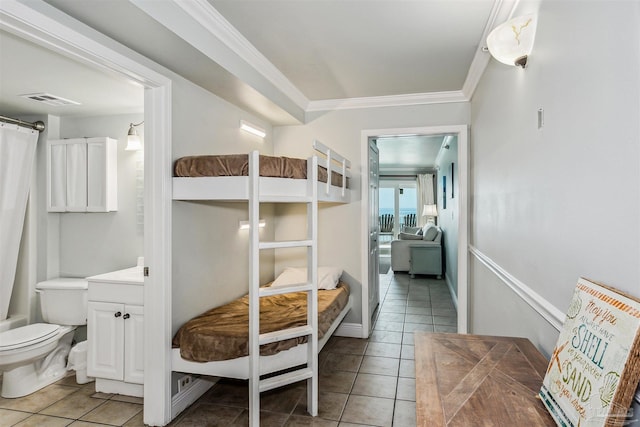 bedroom featuring connected bathroom, ornamental molding, and light tile patterned flooring