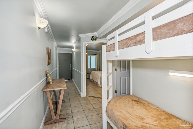 hallway featuring crown molding and light tile patterned flooring