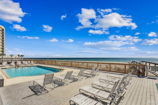 view of pool with a deck with water view