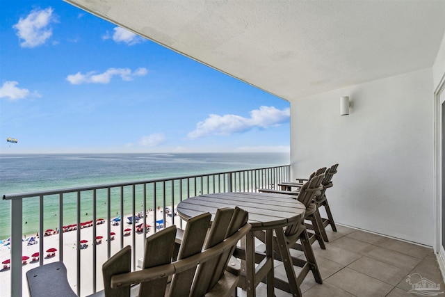 balcony featuring a water view and a beach view