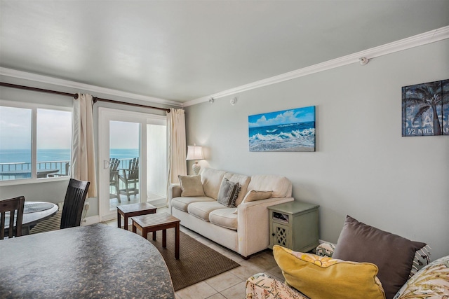 living room featuring ornamental molding, a water view, and light tile patterned floors