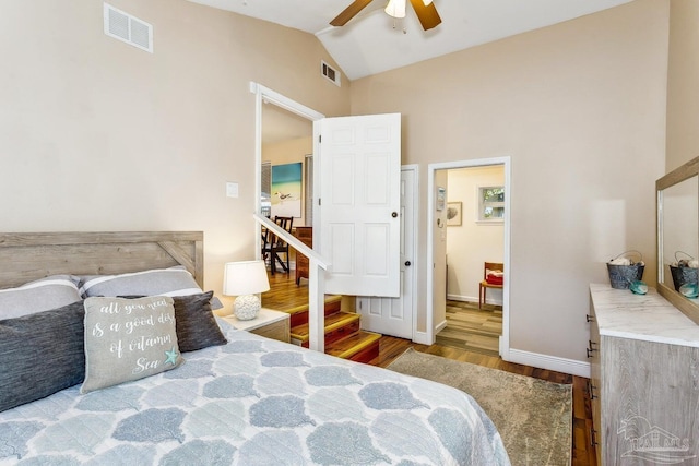 bedroom with lofted ceiling, hardwood / wood-style flooring, and ceiling fan