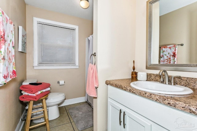 bathroom featuring vanity, tile patterned floors, and toilet