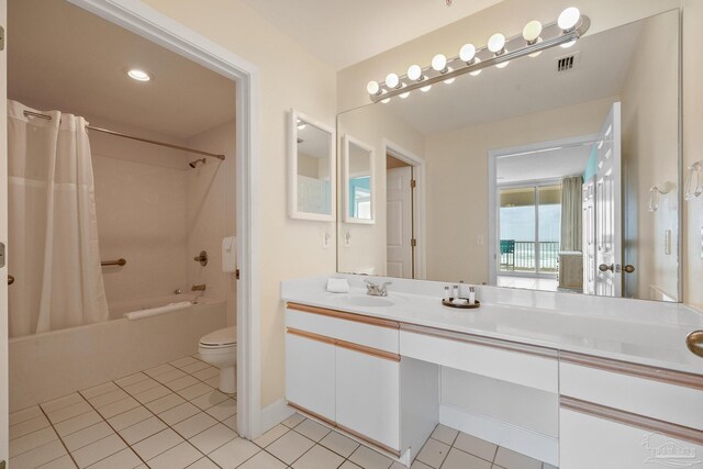 full bathroom featuring vanity, toilet, tile patterned floors, and shower / bath combo