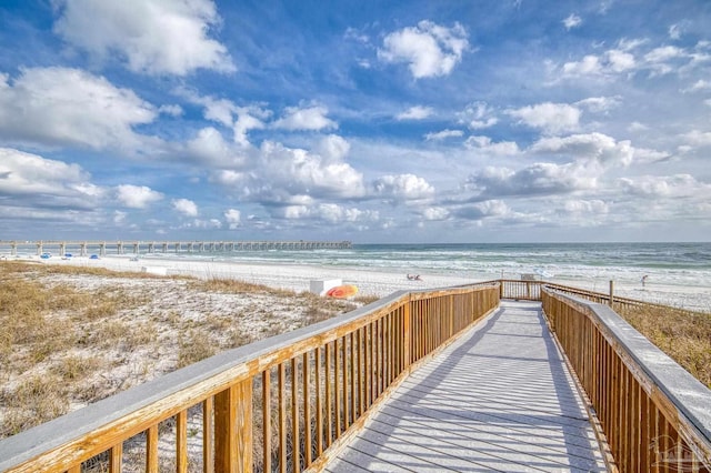 view of home's community with a water view and a beach view