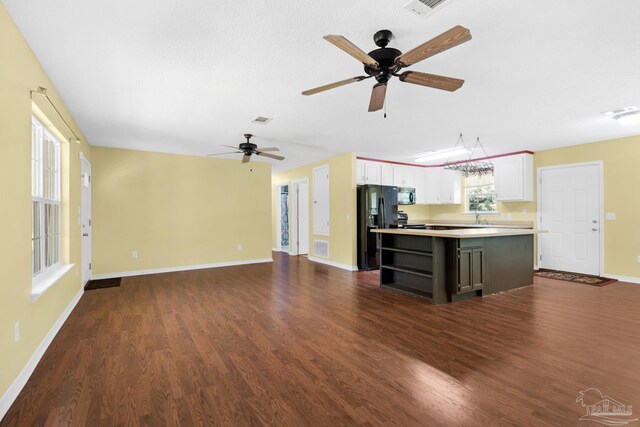 kitchen with black appliances, white cabinets, a kitchen island, dark hardwood / wood-style flooring, and ceiling fan