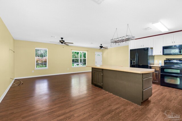 kitchen featuring white cabinets, dark wood-type flooring, a center island, ceiling fan, and black appliances