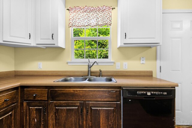 kitchen with black dishwasher, white cabinetry, and sink