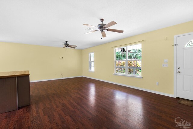 spare room featuring dark hardwood / wood-style floors and ceiling fan