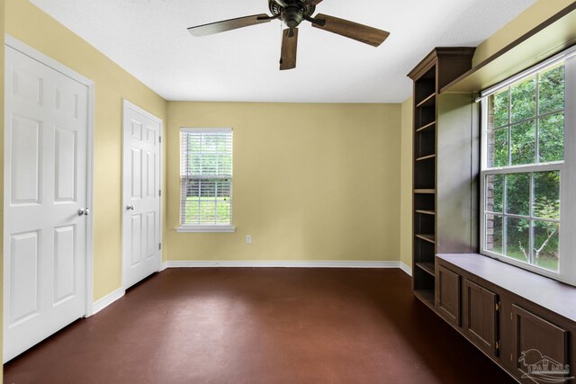 empty room with a healthy amount of sunlight and ceiling fan