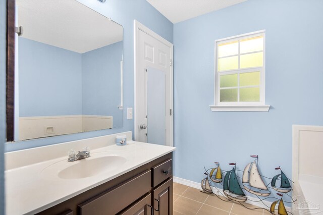 bathroom with tile patterned flooring and vanity