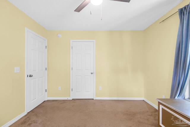 carpeted empty room with ceiling fan