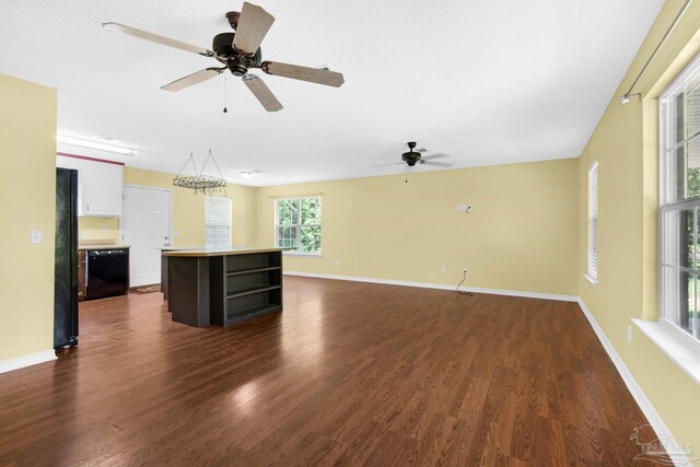 unfurnished living room featuring dark hardwood / wood-style flooring and ceiling fan