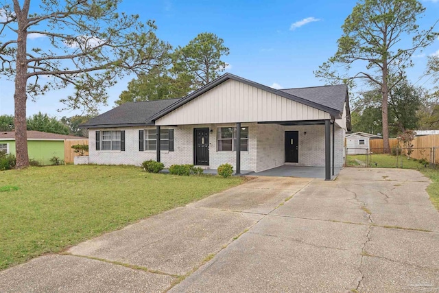 ranch-style home with fence, a front lawn, concrete driveway, and brick siding