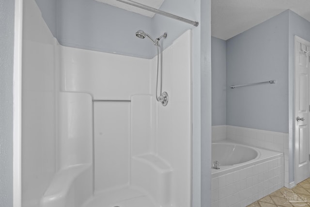 full bath featuring tile patterned floors, a textured ceiling, a stall shower, and a bath