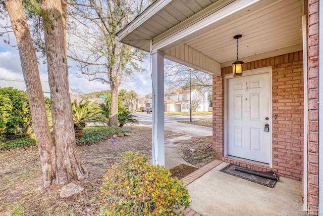 doorway to property with brick siding