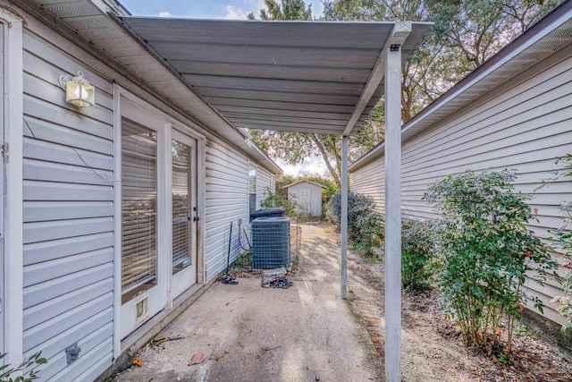 view of patio with a storage unit, central air condition unit, and an outdoor structure