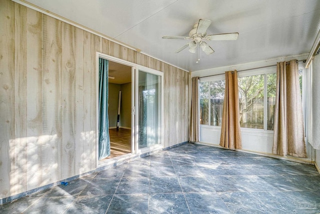 unfurnished sunroom with ceiling fan