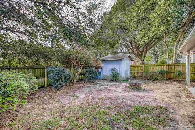 view of yard with a fenced backyard, a storage shed, and an outdoor structure