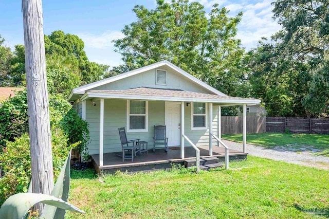 view of front of property with a porch and a front lawn