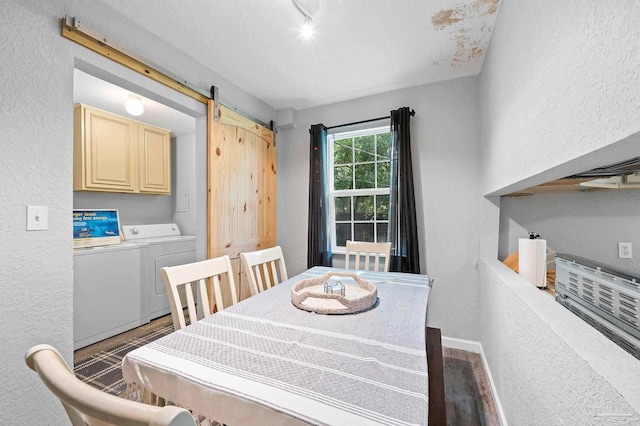 dining room with washer and dryer, a barn door, and dark wood-type flooring