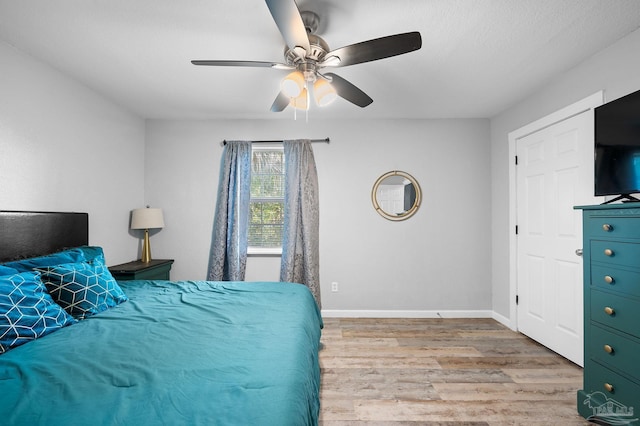 bedroom featuring ceiling fan and light hardwood / wood-style floors