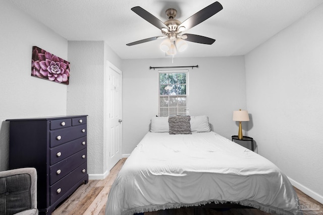 bedroom with ceiling fan and light hardwood / wood-style flooring