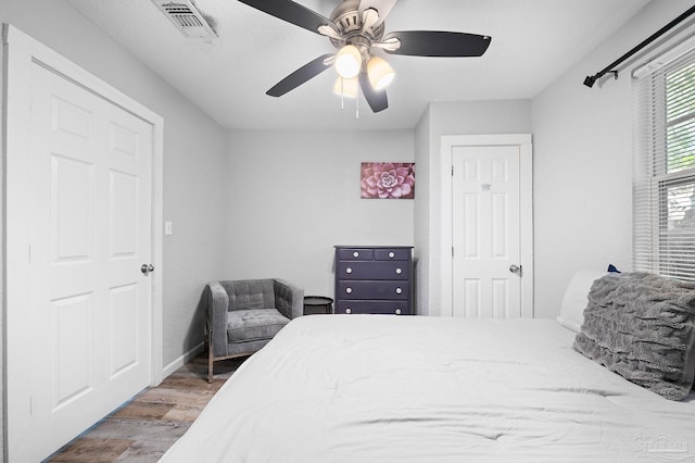 bedroom with hardwood / wood-style flooring and ceiling fan