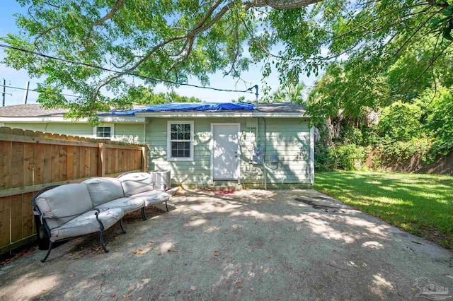 back of house featuring cooling unit, a patio area, and a yard