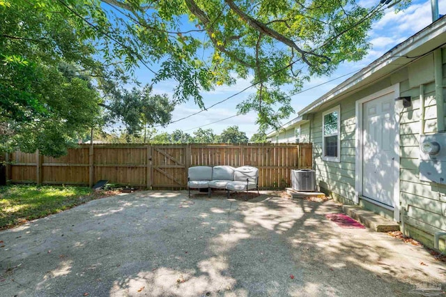 view of yard featuring central AC unit and a patio