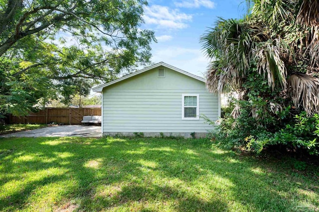 view of side of home with a yard