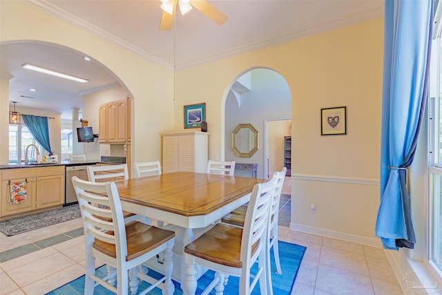 dining space with crown molding, light tile patterned floors, and ceiling fan