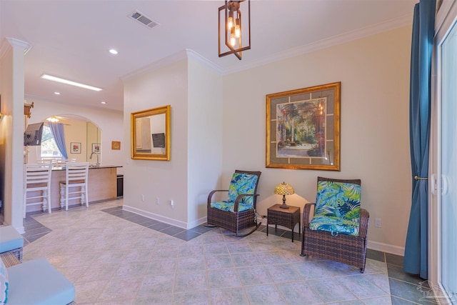 living area with crown molding and tile patterned floors