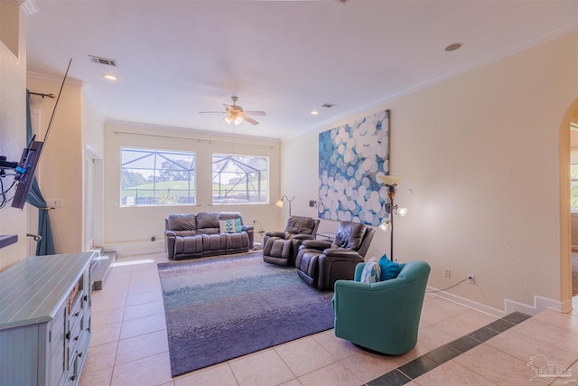 living room featuring crown molding, ceiling fan, and light tile patterned floors