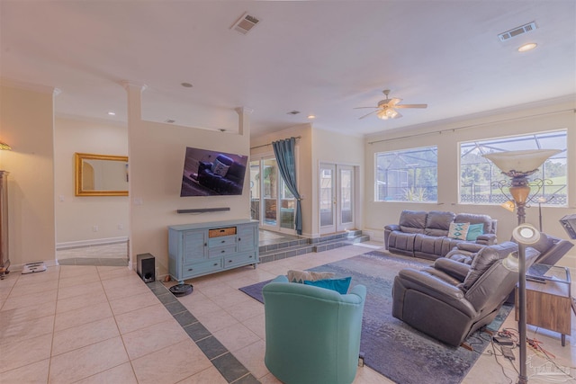 tiled living room featuring ornamental molding and ceiling fan