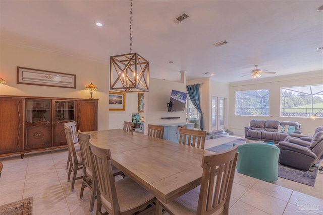 dining room with ceiling fan with notable chandelier and light tile patterned flooring