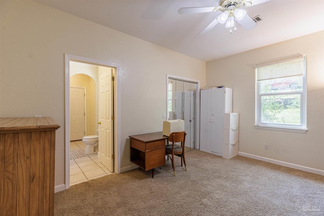 carpeted office space with ceiling fan