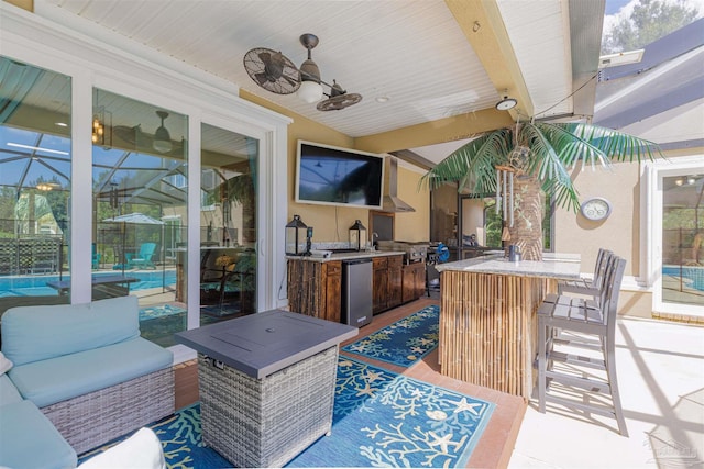 view of patio featuring an outdoor bar and ceiling fan