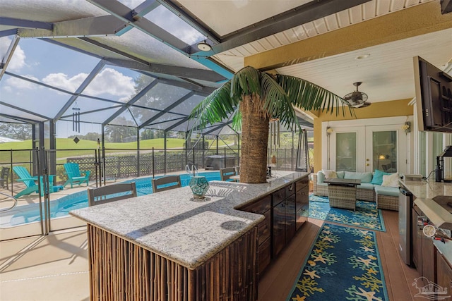 view of patio / terrace with french doors, an outdoor hangout area, a lanai, and ceiling fan