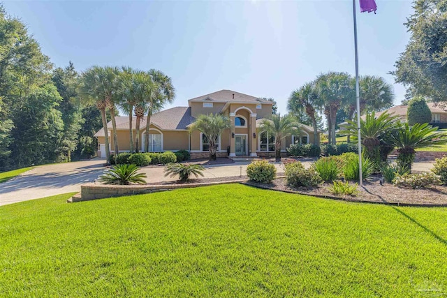 mediterranean / spanish-style house with a front yard