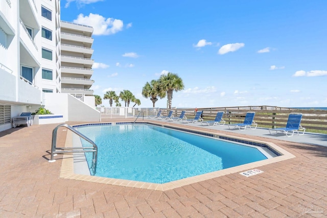 community pool with a patio area